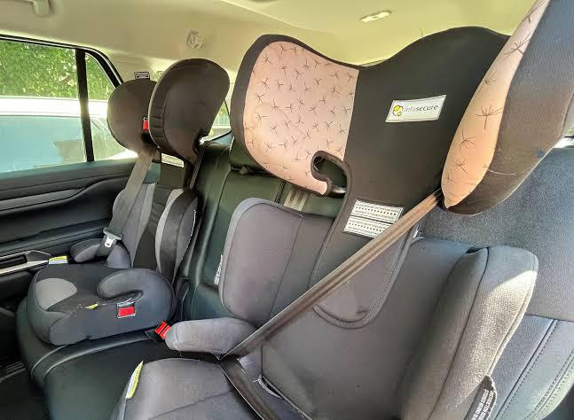 Booster seat with properly positioned sash belt